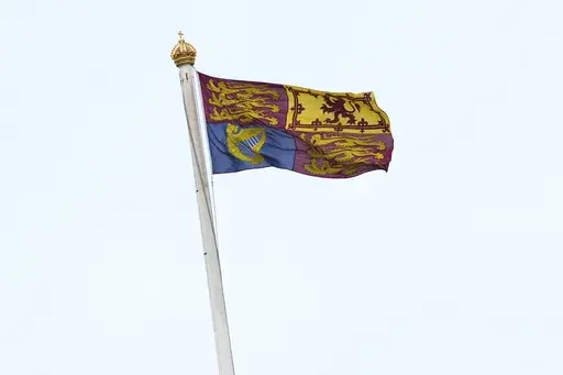 The Royal Standard flag is pictured flying from the Roof of Buckingham Palace in London, Friday, March 28, 2025, after the Palace said King Charles III was hospitalized for observation on Thursday, experiencing "temporary side effects,'' related to a scheduled cancer treatment. (AP Photo/Kirsty Wigglesworth)