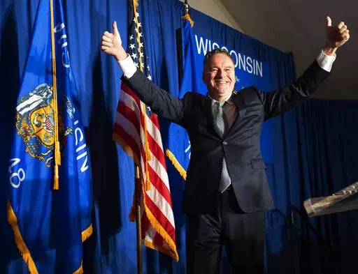 Tim Michels bounds on stage to claim victory in the Republican primary for governor, late Tuesday, Aug. 9, 2022, at Tuscan Hall Venue and Catering in Waukesha, Wis. He will face incumbent Gov. Tony Evers, a Democrat, in the general election. (Mark Hoffman/Milwaukee Journal-Sentinel via AP)