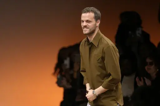 Creative director Matthieu Blazy accepts applause after the conclusion of the Bottega Veneta women's Fall-Winter 2024-25 collection presented in Milan, Italy, Feb. 24, 2024. (AP Photo/Luca Bruno, file)