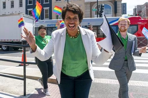 District of Columbia Mayor Muriel Bowser, center, arrives for a news conference ahead of DC Pride events, Friday, June 10, 2022, in Washington. At right is Japer Bowles, director of the Mayor's Office of Lesbian, Gay, Bisexual, Transgender and Questioning Affairs. Bowser is seeking a third term in office. (AP Photo/Jacquelyn Martin)