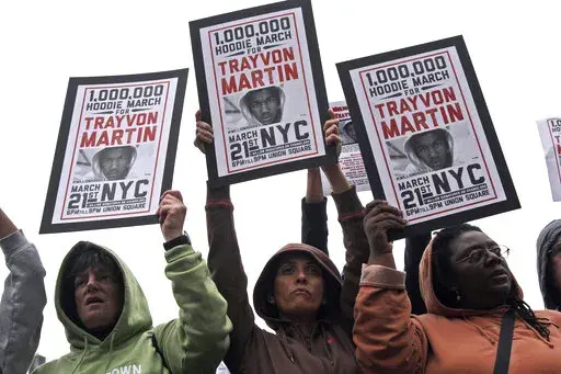 Demonstrators hold signs in support of Trayvon Martin in Union Square Wednesday, March 21, 2012 in New York.  Ten years ago when Trayvon Martin was fatally shot, Florida was one of the few states with “stand your ground” laws that eased use of deadly force in the face of danger. Now, upwards of 30 states have some form of the law and recent research indicates they're associated with more deaths _ as many as 700 additional gun killings each year, according to a study published this week in th