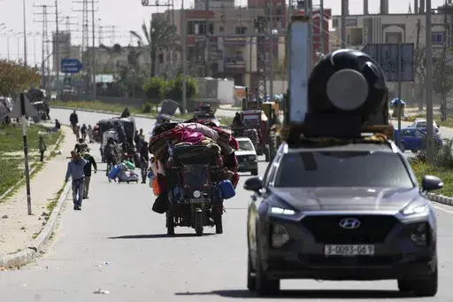 Displaced Palestinians, who flee from Rafah, arrive in Khan Younis, Gaza, on Monday, March 31, 2025, after the Israeli military issued sweeping evacuation orders covering most of Rafah. (AP Photo/Abdel Kareem Hana)