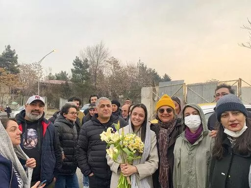 Iranian prominent actress Taraneh Alidoosti, center, holds bunches of flowers as she poses for a photo among her friends after being released from Evin prison in Tehran, Iran, Wednesday, Jan. 4, 2023. Iran released Alidoosti, a prominent actress from an Oscar-winning film, nearly three weeks after she was jailed for criticizing a crackdown on anti-government protests. (Gisoo Faghfouri, Sharghdaily, via AP)
