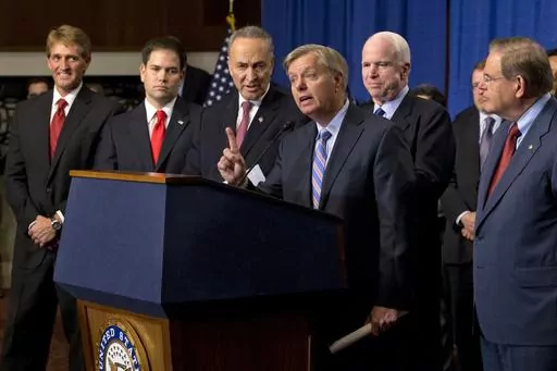 Sen. Lindsey Graham, R-S.C., center, speaks of immigration reform legislation outlined by the Senate's bipartisan "Gang of Eight" that would create a path for the nation's 11 million unauthorized immigrants to apply for U.S. citizenship, April 18, 2013, on Capitol Hill in Washington. From left are, Sen. Jeff Flake, R-Ariz., Sen. Marco Rubio, R-Fla., Sen. Charles Schumer, Graham, R-S.C., Sen. John McCain, R-Ariz., Sen. Robert Menendez, D-N.J., and Senate Majority Whip Richard Durbin, D-Ill. (AP P