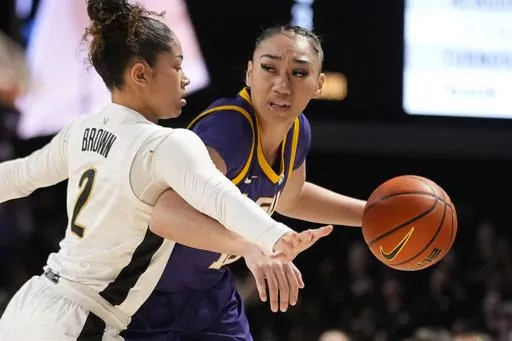 LSU guard Last-Tear Poa, right, dribbles the ball past Vanderbilt guard Jada Brown (2) during the first half of an NCAA college basketball game Thursday, Feb. 8, 2024, in Nashville, Tenn. (AP Photo/George Walker IV)