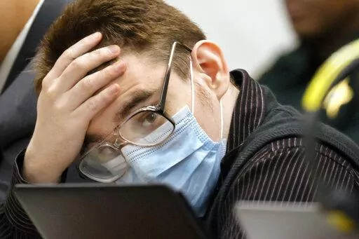Marjory Stoneman Douglas High School shooter Nikolas Cruz listens to testimony while seated at the defense table during the penalty phase of his trial at the Broward County Courthouse, Friday, July 22, 2022, in Fort Lauderdale, Fla. Cruz previously plead guilty to all 17 counts of premeditated murder and 17 counts of attempted murder in the 2018 shootings. (Mike Stocker/South Florida Sun-Sentinel via AP, Pool, File)