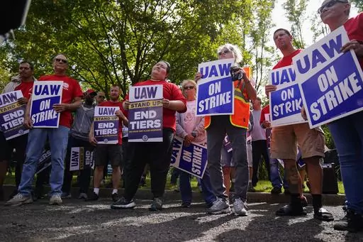 United Auto Workers members and supporters picket outside a General Motors facility in Langhorne, Pa., Friday, Sept. 22, 2023. The United Auto Workers expanded its strike against major automakers Friday, walking out of 38 General Motors and Stellantis parts distribution centers in 20 states. (AP Photo/Matt Rourke)