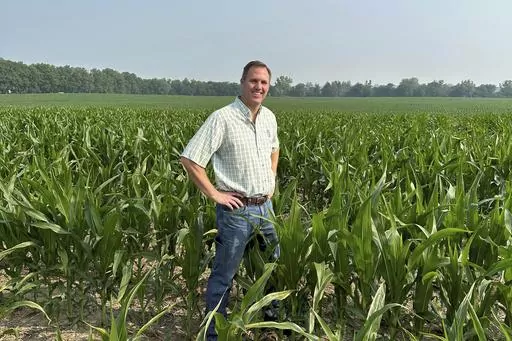 This photo provided by Mike Shane shows Shane as he stands in his corn field near Peoria, Ill., Tuesday, June 27, 2023. By now, the corn stalks should be 10 feet high. Instead, they’re barely up to Shane’s waist. Illinois and other corn-growing states in the central U.S. have been hit hard by drought, prompting concerns that the crop will be hurt this year. (Mack Foster/Mike Shane via AP)