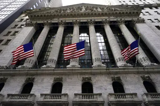 American flags fly outside the New York Stock exchange, Friday, Jan. 14, 2022, in the Financial District in New York. Stocks are off to a weak start on Wall Street, Thursday, Feb. 17, chipping away at the weekly gains for major indexes.  (AP Photo/Mary Altaffer, File)