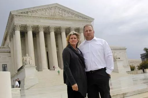 Michael and Chantell Sackett of Priest Lake, Idaho, pose for a photo in front of the Supreme Court in Washington on Oct. 14, 2011. The Supreme Court on Thursday, May 25, 2023, made it harder for the federal government to police water pollution in a decision that strips protections from wetlands that are isolated from larger bodies of water. The justices boosted property rights over concerns about clean water in a ruling in favor of an Idaho couple who sought to build a house near Priest Lake in 