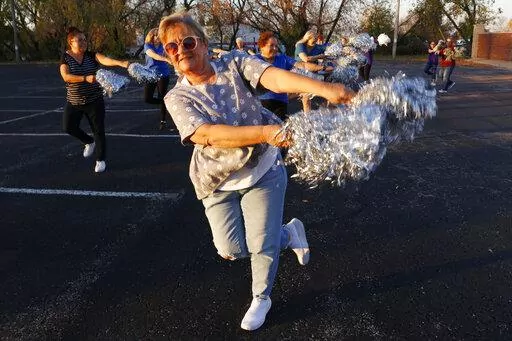 Pam Junion, 65, and other members of the Milwaukee Dancing Grannies practice in a parking lot in Milwaukee on Wednesday, Nov. 2, 2022. Junion is one of a few women who answered a call for new members as the group attempted to rebuild in the face of tragedy. Three Dancing Grannies and one group member’s husband were among those killed at a Christmas parade in Waukesha, Wisconsin, when the driver of an SUV struck them on the parade route. Dozens more, including some Grannies, were injured. (AP P