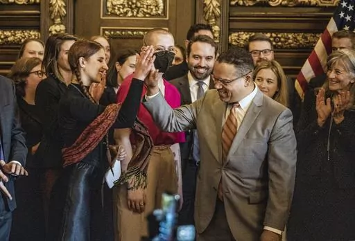 Attorney General Keith Ellison gives a high five to Katy Johnson, who was once addicted to vaping in St. Paul, Minn., on Wednesday, May 17, 2023. innesota says it settled its lawsuit against e-cigarette maker Juul Labs and tobacco giant Altria for $60.5 million. The state’s lawsuit was the first and still the only one of thousands of cases nationwide against the e-cigarette maker to reach trial. (Richard Tsong-Taatarii/Star Tribune via AP)