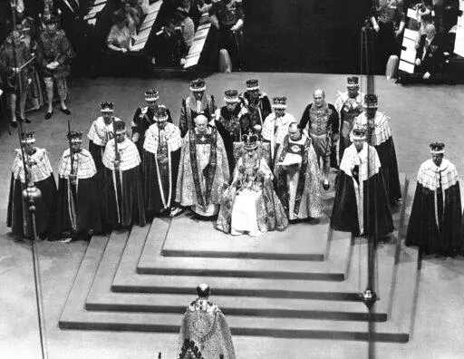 Surrounded by peers and churchmen, Queen Elizabeth II sits on throne in Westminister Abbey, London, June 2, 1953 after her coronation. Britain is marking Queen Elizabeth II's Platinum Jubilee on Sunday, Feb. 6, 2022, 70 years after she ascended to the throne. (AP Photo, File)