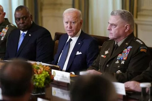 President Joe Biden meets with military leaders, including Defense Secretary Lloyd Austin, left, and Chairman of the Joint Chiefs of Staff Gen. Mark Milley, in the State Dining Room of the White House in Washington, Wednesday, Oct. 26, 2022. (AP Photo/Susan Walsh)