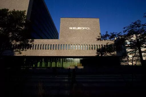 FILE- This Wednesday, Oct. 10, 2018, file photo shows the sun bouncing off the Europol headquarters in The Hague, Netherlands. Europol says law enforcement authorities in six different countries have joined forces to take down a “super cartel” of drugs traffickers controlling about one third of the cocaine trade in Europe. (AP Photo/Peter Dejong, File)