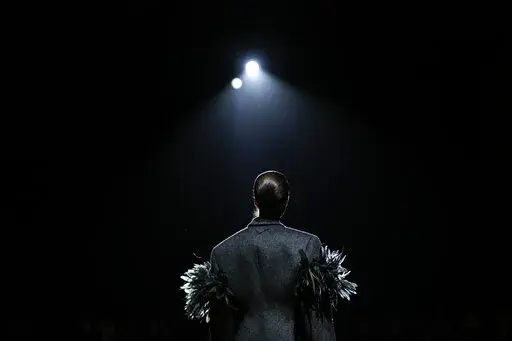 A model wears a creation as part of the Prada Fall/Winter 2022-2023 fashion collection, unveiled during the Fashion Week in Milan, Italy, Thursday, Feb. 24, 2022. (AP Photo/Luca Bruno)