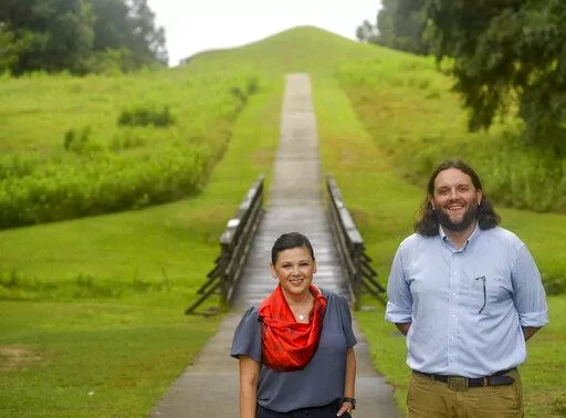 Tracie Revis, left, a citizen of the Muscogee Creek Nation, and Seth Clark, mayor pro-tem of Macon, stand at the approach to the Earth Lodge, where Native Americans held council meetings for 1,000 years until their forced removal in the 1820s, on Aug. 22, 2022, in Macon, Ga. Revis and Clark are co-directors of an initiative to bring 50 miles of the Ocmulgee River under federal protection as a national park. (AP Photo/Sharon Johnson)