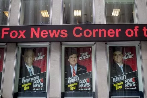 Posters of Fox News Channel personalities are displayed at the News Corp. headquarters in New York, April 19, 2017. Oregon's attorney general announced Monday, June 5, 2023, she has begun investigating the board of directors of Fox Corp., for breaching its fiduciary duties by allowing Fox News to broadcast false claims about the 2020 presidential election, claims that cost the broadcaster almost $800 million in a lawsuit. (AP Photo/Mary Altaffer, File)