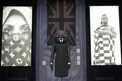 A black union jack shawl, Madhatter crown hat and Rudie coat designed by London-based art collective Art Comes First, are displayed during a preview of the exhibition titled "The Missing Thread: Untold Stories of Black British Fashion", at Somerset House, in London, Tuesday, Sept. 19, 2023. A new exhibition is opening in London to chart for the first time the contributions Black British culture made to U.K. fashion and design history and to celebrate Black designers who have not received public 