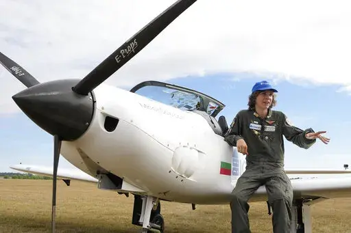 Seventeen year old Anglo-Belgian pilot, Mack Rutherford, speaks with the media after landing at the Buzet airfield in Pont-A-Celles, Belgium, Tuesday, Aug. 23, 2022. Rutherford landed in Belgium before flying on to Slovakia and Sofia, Bulgaria, for the final leg of his Guinness World Record attempt to be the youngest person to the fly around the world solo in a small plane. (AP Photo/Virginia Mayo)