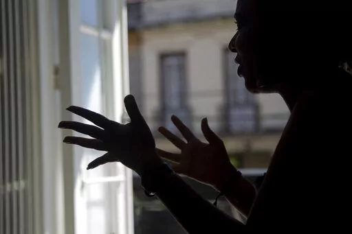 Diana gives an interview in Havana, Cuba, Thursday, Nov. 3, 2022. Diana said she endured screams, insults and confinement for seven years before she ended a seven year relationship with her boyfriend, but that she did not reach out to any institutions or programs that handled cases of violence against women because she had no faith that they could protect her. Diana asked that her last name not be published because she was afraid for her safety.  (AP Photo/Ismael Francisco)