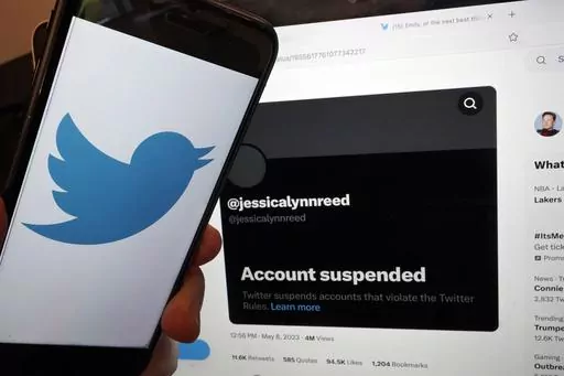 This Thursday, May 11, 2023, image taken in New York, shows the account suspended notice of Jessica Reed on the Twitter page of her younger sister Emily Reed. On Monday, May 8, 2023, Twitter CEO Elon Musk announced the platform would be "purging accounts that have had no activity at all for several years." The news caused outrage among people fearing they could lose tweets that now-inactive accounts, including those belonging to users who have died, left behind on the app. (AP Photo/Richard Drew