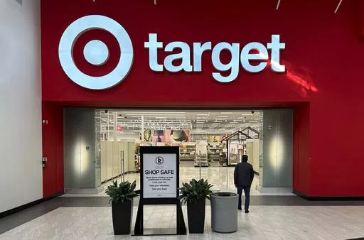 A shopper heads into a Target store Jan. 11, 2024, in Lakewood, Colo. Target plans on cutting prices on thousands of consumer basics this summer, goods ranging from diapers to milk, with more Americans paying closer attention to their spending as inflation cuts into household budgets. (AP Photo/David Zalubowski, File)