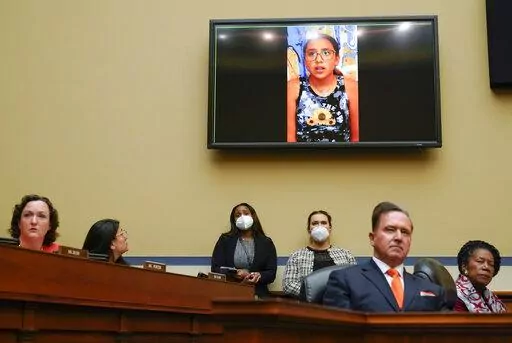 Miah Cerrillo, a fourth grade student at Robb Elementary School in Uvalde, Texas, and survivor of the mass shooting appears on a screen during a House Committee on Oversight and Reform hearing on gun violence on Capitol Hill in Washington, Wednesday, June 8, 2022. (AP Photo/Andrew Harnik, Pool)