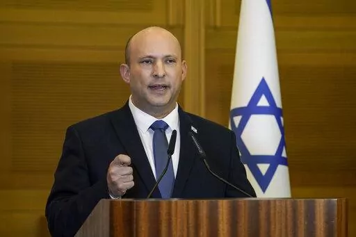 Israeli Prime Minister Naftali Bennett delivers a statement at the Knesset, Israel's parliament, in Jerusalem on June 29, 2022. Bennett, a former Israeli prime minister who served briefly as a mediator at the start of Russia's war with Ukraine, said during an interview posted online Saturday, Feb. 4, 2023, he drew a promise from the Russian president not to kill his Ukrainian counterpart. (AP Photo/Tsafrir Abayov, File)