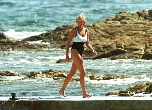 Britain's Diana, Princess of Wales walks on the quay of the residence of Mohamed Al Fayed, in Saint Tropez, French Riviera, Sunday July 20, 1997. It has been nearly 25 years since Princess Diana died in a high-speed car crash in Paris. The French doctor who treated her at the scene has recounted what happened. Dr. Frederic Mailliez told The Associated Press how he tried to save her on that night of Aug. 31, 1997. (AP Photo/Lionel Cironneau, File)
