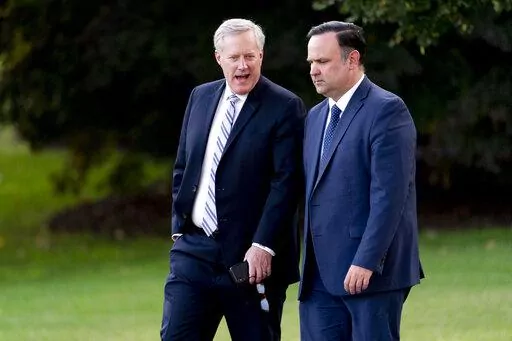 White House social media director Dan Scavino, right, and White House chief of staff Mark Meadows, left, walk to board Marine One with President Donald Trump on the South Lawn of the White House, Tuesday, Sept. 22, 2020, in Washington. According to a person familiar with a letter sent by the Justice Department to a lawyer for the House of Representatives on Friday, June 3, 2022, the Justice Department has declined to charge former White House chief of staff Meadows and Scavino for contempt of Co