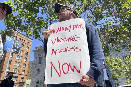 A man holds a sign urging increased access to the monkeypox vaccine during a protest in San Francisco, July 18, 2022. California's governor on Monday, Aug. 1, 2022, declared a state of emergency to speed efforts to combat the monkeypox outbreak, becoming the second state in three days to take the step. (AP Photo/Haven Daley, File)