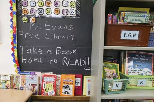 Books are displayed on a free library shelf inside the classroom of Richard Evans, a teacher at Hyde Park Elementary School, on Thursday, Oct. 20, 2022, in Niagara Falls, N.Y. Stuck with distance learning as they began grade school, the kids who are now finishing elementary school were the ones most disrupted by COVID, with alarming delays in their reading ability. (AP Photo/Joshua Bessex, File)