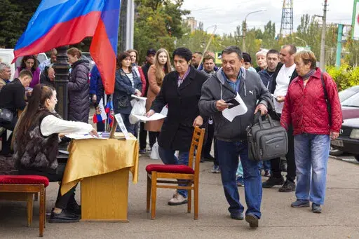 People line up to vote in a referendum in Luhansk, Luhansk People's Republic controlled by Russia-backed separatists, eastern Ukraine, Sept. 24, 2022. Voting began Friday in four Moscow-held regions of Ukraine on referendums to become part of Russia. (AP Photo/File)