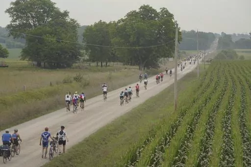 Riders take a gravel detour outside Colfax, Iowa, as RAGBRAI 50 heads to Tama-Toledo on Thursday, July 27, 2023. (Zach Boyden-Holmes/The Des Moines Register via AP)