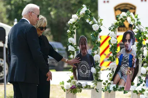President Joe Biden and first lady Jill Biden visit a memorial at Robb Elementary School to pay their respects to the victims of the mass shooting, Sunday, May 29, 2022, in Uvalde, Texas. (AP Photo/Evan Vucci)