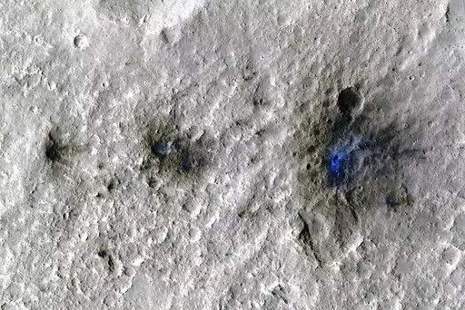 This undated photo released by NASA shows craters that were formed by a Sept. 5, 2021, meteoroid impact on Mars, the first to be detected by NASA’s InSight. Taken by NASA’s Mars Reconnaissance Orbiter, this enhanced-color image highlights the dust and soil disturbed by the impact in blue in order to make details more visible to the human eye. NASA lander on Mars has captured the vibrations and sounds of four meteorites striking the planet's surface. Scientists reported Monday, Sept. 19, 2022