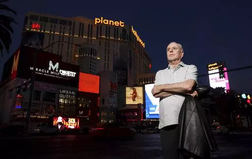 Jeff German, host of "Mobbed Up," poses with Planet Hollywood, formerly the Aladdin, in the background on the Strip in Las Vegas, Wednesday, June 2, 2021. Authorities say German, a Las Vegas investigative reporter has been stabbed to death outside his home and police are searching for a suspect. The Las Vegas Review-Journal says officers found journalist German dead with stab wounds around 10:30 a.m. Saturday, Sept. 3, 2022, after authorities received a 911 call. (K.M. Cannon/Las Vegas Review-Jo