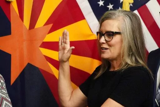 The new Arizona Democratic Gov. Katie Hobbs takes the oath of office in a ceremony at the state Capitol in Phoenix, Monday, Jan. 2, 2023. (AP Photo/Ross D. Franklin, Pool)