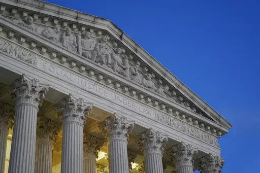 Light illuminates part of the Supreme Court building at dusk on Capitol Hill in Washington, Nov. 16, 2022. The Supreme Court said Thursday, Jan. 19, 2023, that it has not determined who leaked a draft of the court's opinion overturning abortion rights, but that the investigation continues. (AP Photo/Patrick Semansky, File)