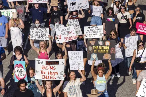 Hundreds of demonstrators rally and march in opposition to the U.S. Supreme Court's decision overturning Roe v. Wade in downtown Raleigh, N.C., on June, 24, 2022. Abortions in North Carolina are no longer legal after 20 weeks of pregnancy, a federal judge ruled Wednesday, Aug. 17, 2022 eroding protections in one of the South’s few remaining safe havens for reproductive freedom. (Travis Long/The News & Observer via AP, File)