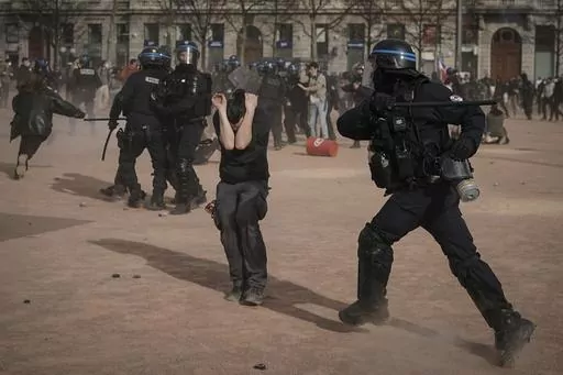 Police officers scuffle with protesters during a demonstration in Lyon, central France, on March 23, 2023. French authorities see the police as protectors ensuring that citizens can peacefully protest President Emmanuel Macron’s contentious retirement age increase. But to human rights advocates and demonstrators who were clubbed or tear-gassed, officers have overstepped their mission. (AP Photo/Laurent Cipriani, File)