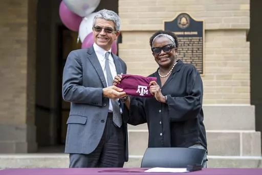 Former Interim Dean of the College of Arts and Sciences José Luis Bermúdez, left, welcomes Kathleen McElroy as the Department of Communication and Journalism's director of journalism at a ceremony in front of A&M's Academic Building, Tuesday, June 13, 2023, in College Station, Texas. (Meredith Seaver/College Station Eagle via AP)
