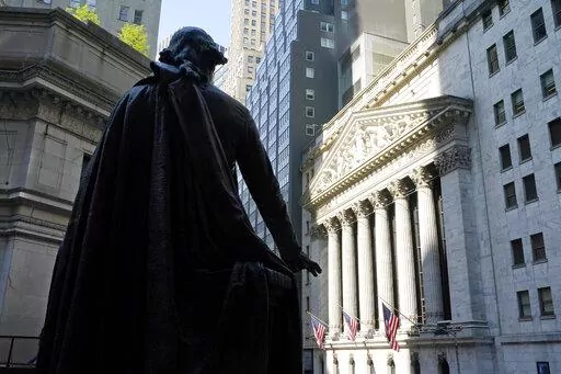 In this June 7, 2021 file photo, The Federal Hall statue of George Washington overlooks the New York Stock Exchange on June 7, 2021, in New York. Democrats have pulled off a quiet first in legislation passed this month: the creation of a tax targeting stock buybacks. The bill includes a new 1% excise tax on companies' purchases of their own shares, a tactic that companies have long used to return cash to investors and bolster their stock's price. (AP Photo/Richard Drew, File)