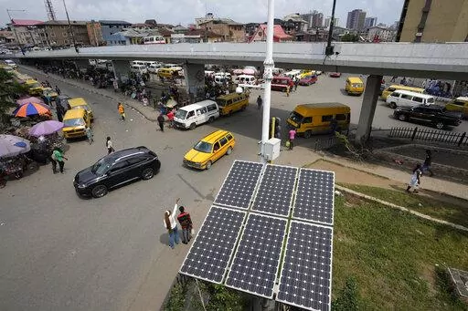 Solar panels sit near a street in the Obalende neighborhood of Lagos, Nigeria, Saturday, Aug. 20, 2022. Access to more and cleaner energy while continuing to grow economically will be a top priority for African nations in the upcoming United Nations climate conference in November, top officials and climate experts on the continent said. (AP Photo/Sunday Alamba)