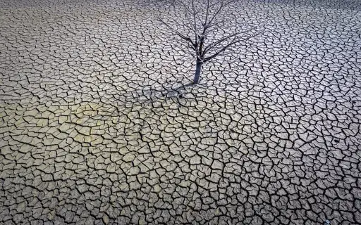 The cracked earth of the Sau reservoir is visible north of Barcelona, Spain, March 20, 2023. Earth last year shattered global annual heat records, the European climate agency said Tuesday, Jan. 9, 2024. (AP Photo/Emilio Morenatti, File)