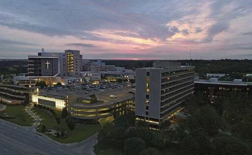 The sun rises over the St. Francis Hospital campus, Thursday, June 2, 2022, in Tulsa, Okla. Authorities say a gunman carrying a rifle and handgun killed four people at a Tulsa medical building on the hospital campus Wednesday. The gunman has not been identified but police say he died of an apparent self-inflicted gunshot wound. (Mike Simons/Tulsa World via AP)