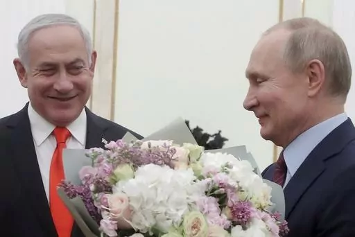 Russian President Vladimir Putin, right, prepares to greet Israeli Prime Minister Benjamin Netanyahu's wife Sara, unseen, prior to talks with Israeli Prime Minister Benjamin Netanyahu in the Kremlin in Moscow, Russia, on Jan. 30, 2020. Russia and Israel have steadily expanded trade and other contacts and strengthened security ties. (Maxim Shemetov/Pool Photo via AP, File)