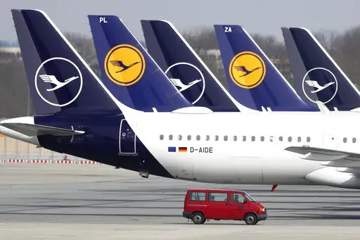 FILE --In this Thursday, March 26, 2020 file photo German Lufthansa planes sit parked in a line at the airport in Munich, Germany.  Lufthansa says it will have to cancel almost all flights at its main Frankfurt and Munich hubs on Wednesday because of a strike by its German ground staff. (AP Photo/Matthias Schrader),file)