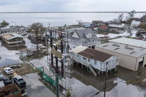 Flood waters surround storm damaged homes on Aug. 31, 2021, in Lafourche Parish, La., as residents try to recover from the effects of Hurricane Ida. Louisiana and nine other states filed a lawsuit against the federal government Thursday, June 1, 2023, to block sharp impending national flood insurance rate increases slated to be phased in over the coming years, saying the steeper costs could cost some people their homes. (AP Photo/Steve Helber)